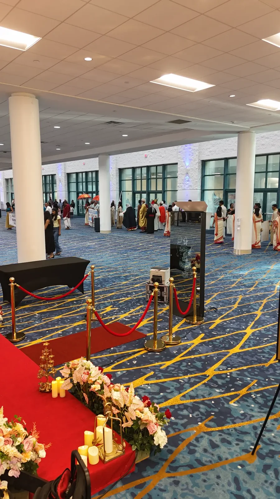 Red-carpet mirror booth setup inside an airy event hall