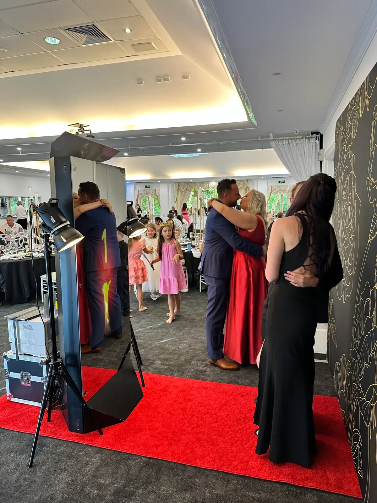 Formal party guests enjoying the Magic Mirror photo booth