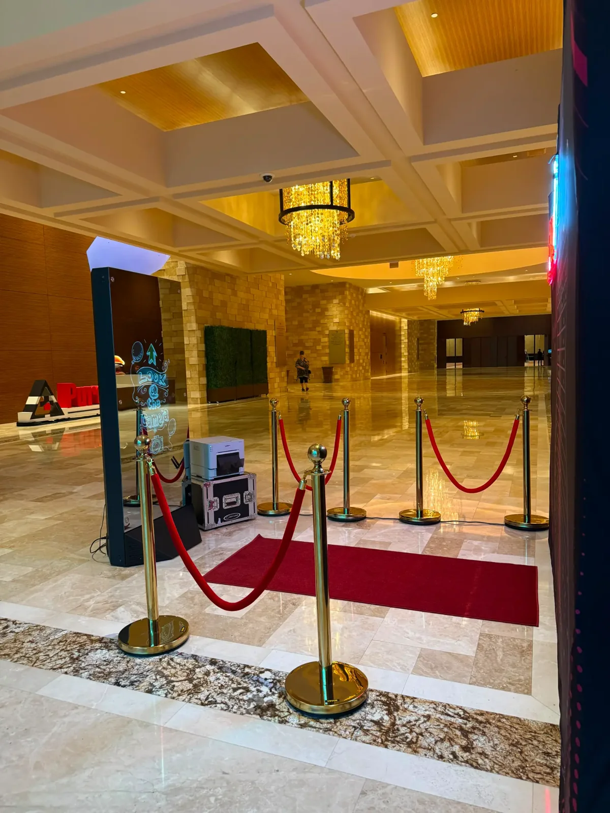 Interactive mirror booth framed by an elegant gold-toned event space