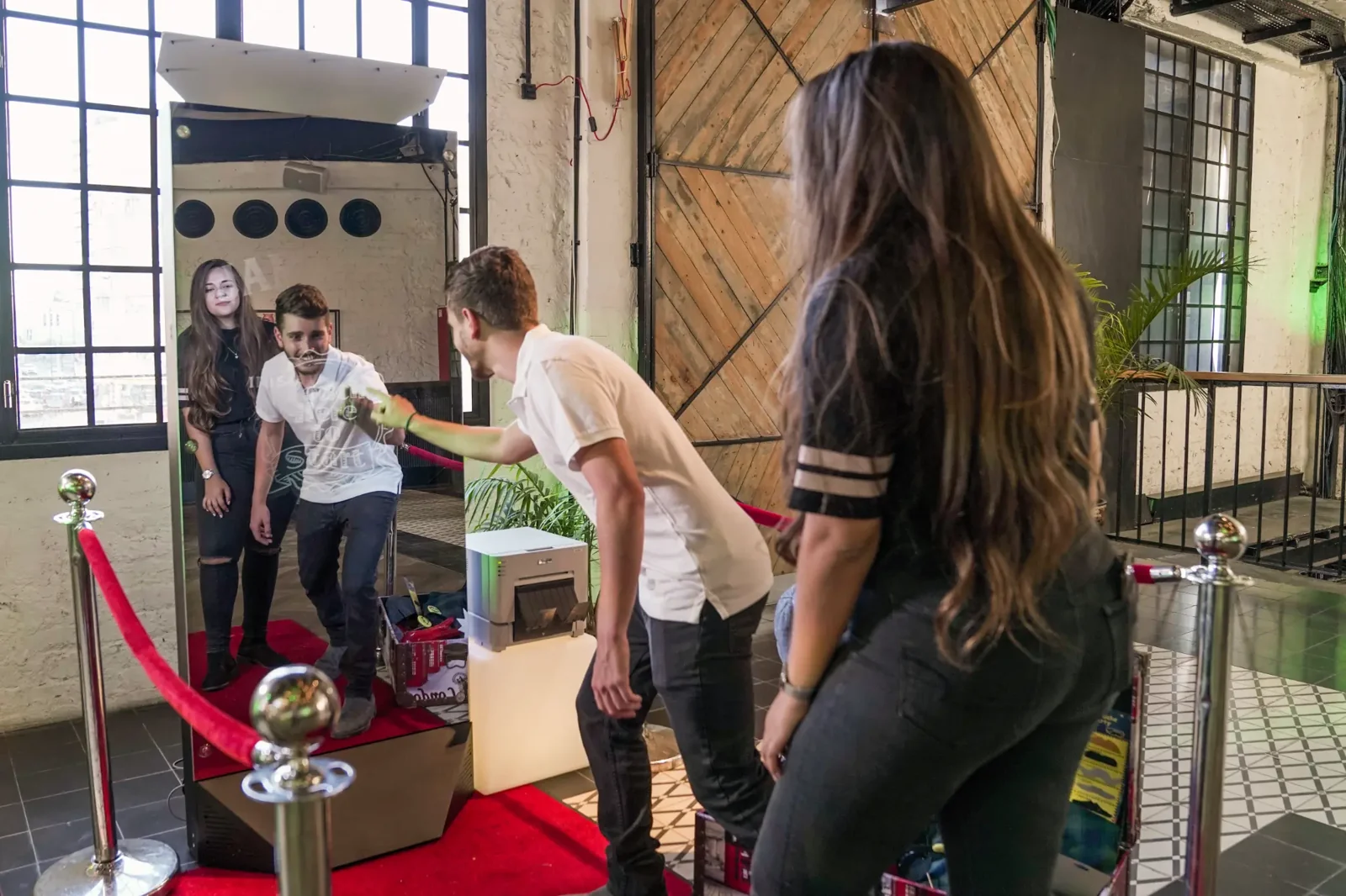 A guest interacting with the touchscreen mirror in a spacious industrial venue