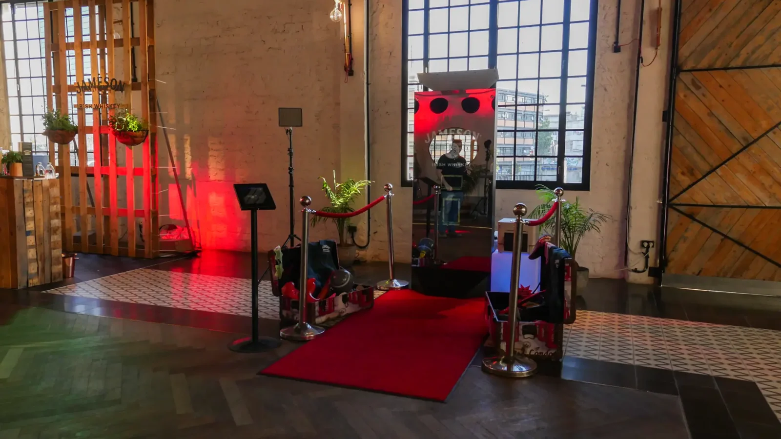 Mirror booth, props table and red carpet lit with red event lights